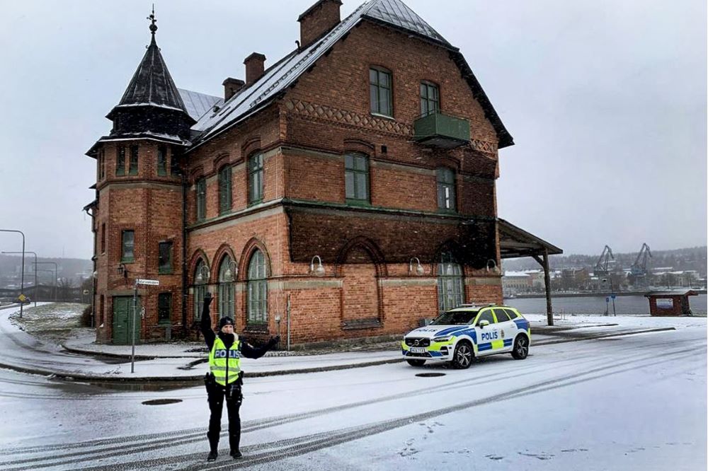 Polisen som håller upp armarna för trafikkontroll.