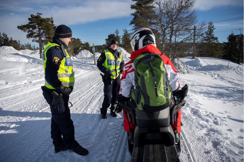 Poliser som håller en skoterkontroll vid en skoterled.